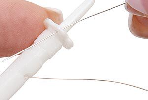 Wire being looped on the wire knitter